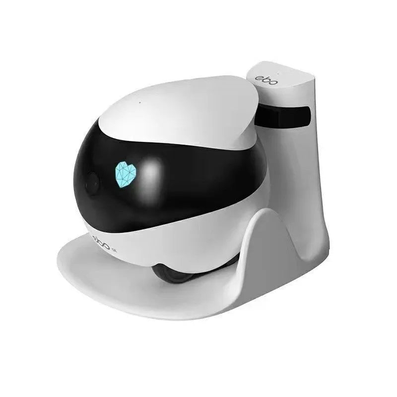 White mobile robot surveillance camera on a charging dock.
