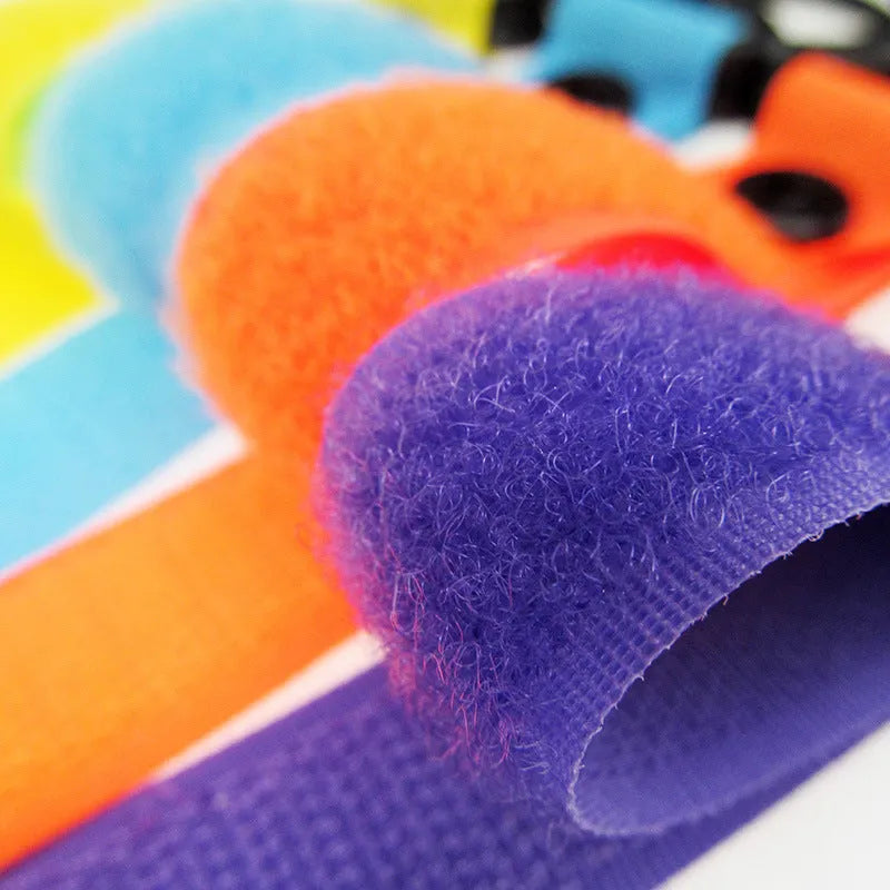 A single nylon Velcro hook for luggage organisation, shown in a selection of its 18 available colours.