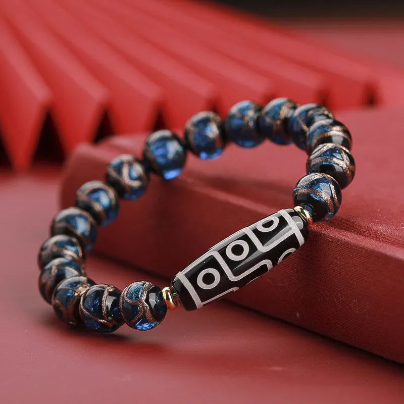 Chinese-style bracelet with coloured glaze beads showing snake and multi-treasure patterns.