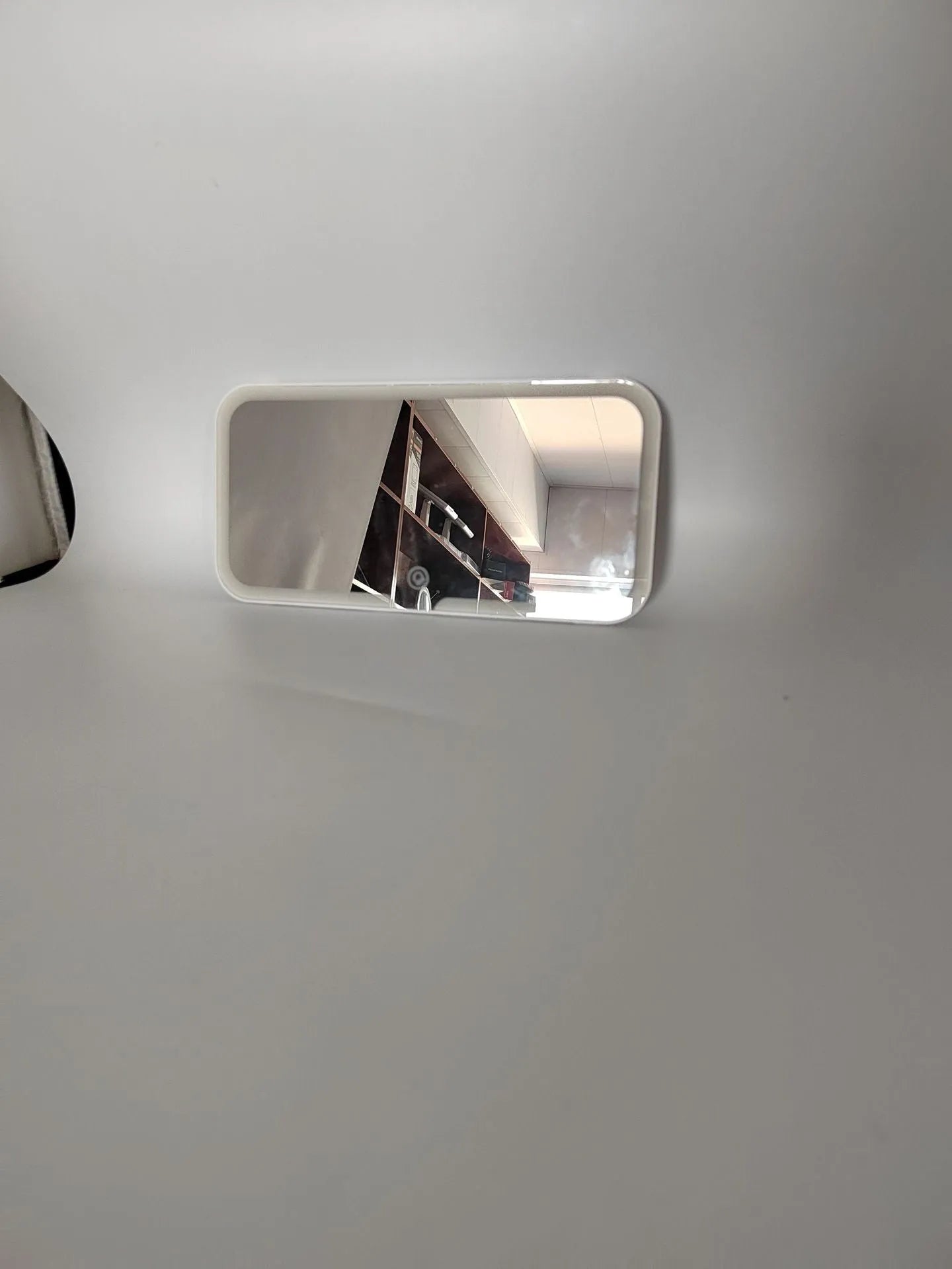 White car sun visor LED make-up mirror with aluminium lens mounted on vehicle visor