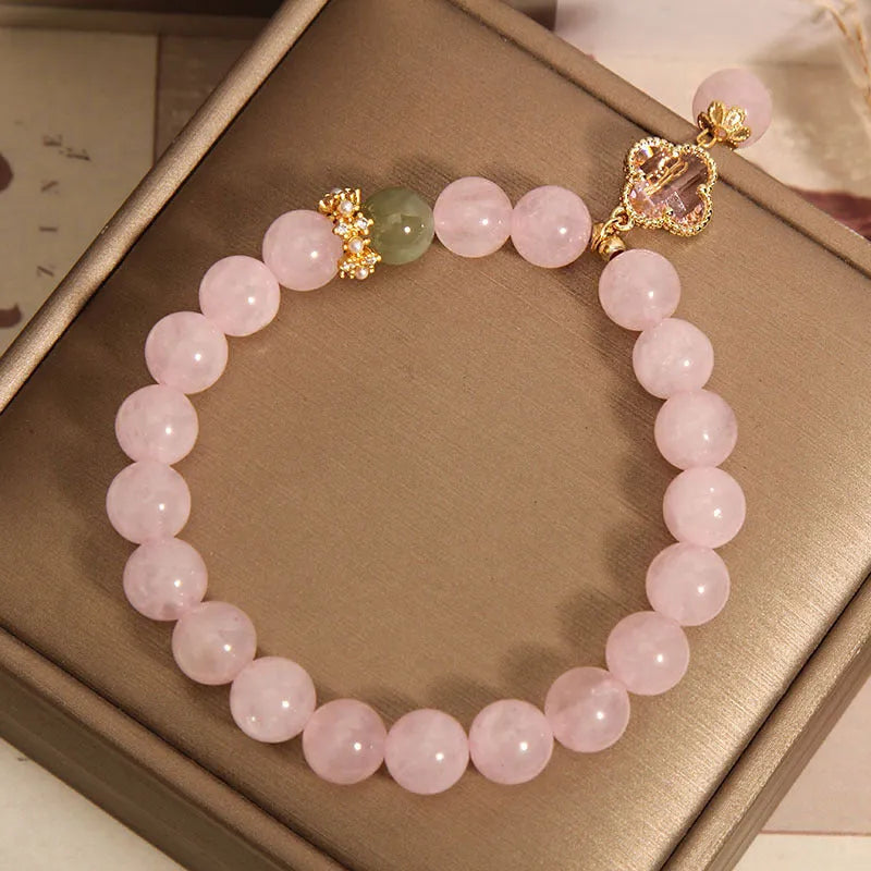 Pink crystal four-leaf clover pendant bracelet with alloy setting and rhinestone details