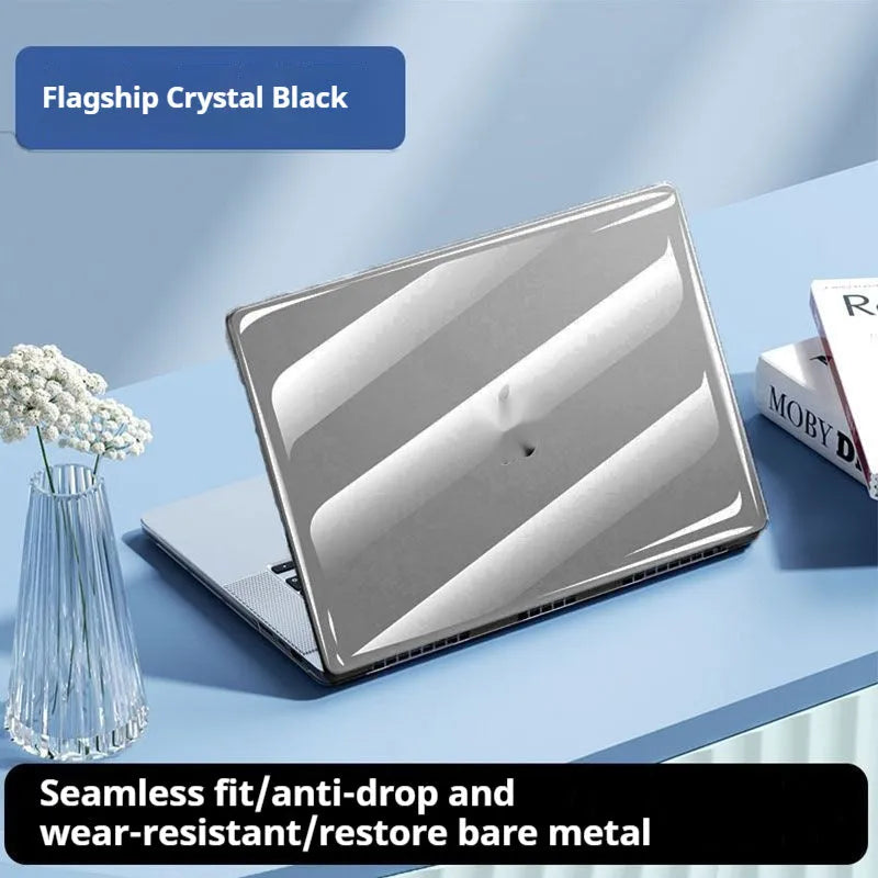 Transparent plastic protective case for a MacBook laptop on a table.