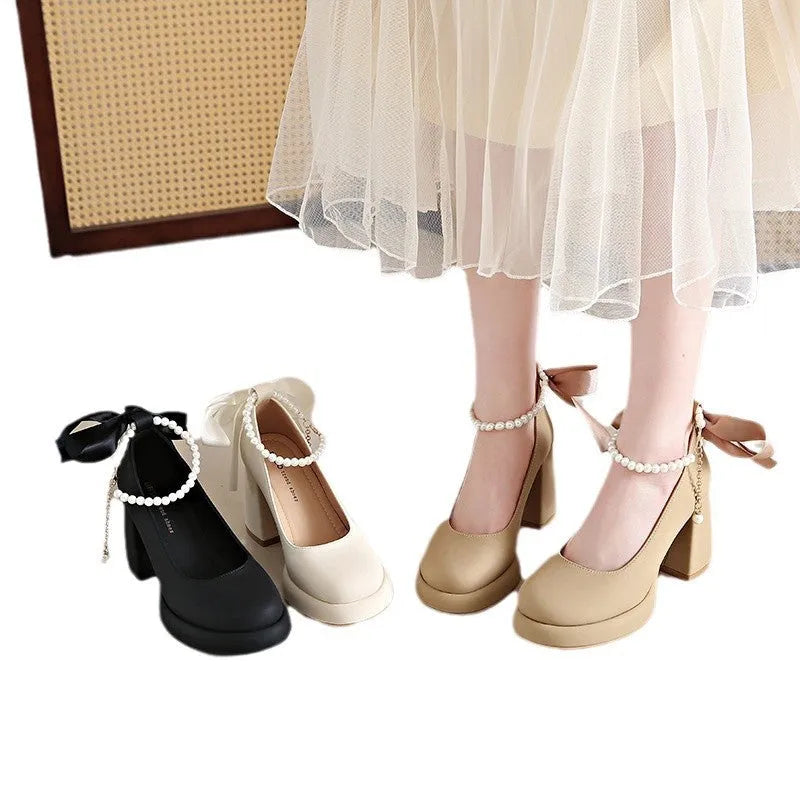 Women's beige Mary Jane shoes with a chunky heel and an adjustable ankle strap buckle.