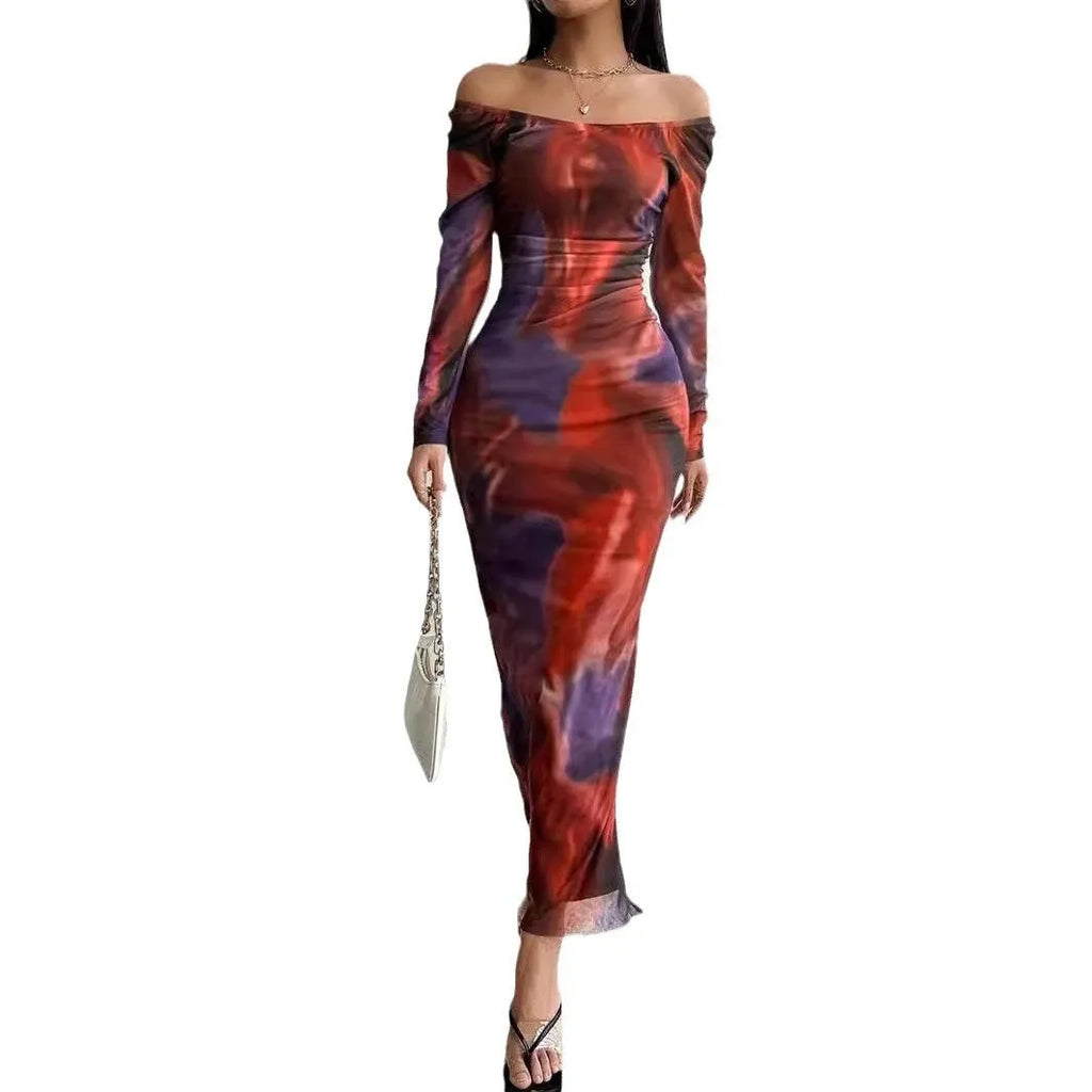 A long green mesh fishtail dress with a square collar, pleated detail, gradient colour, and a split hem.