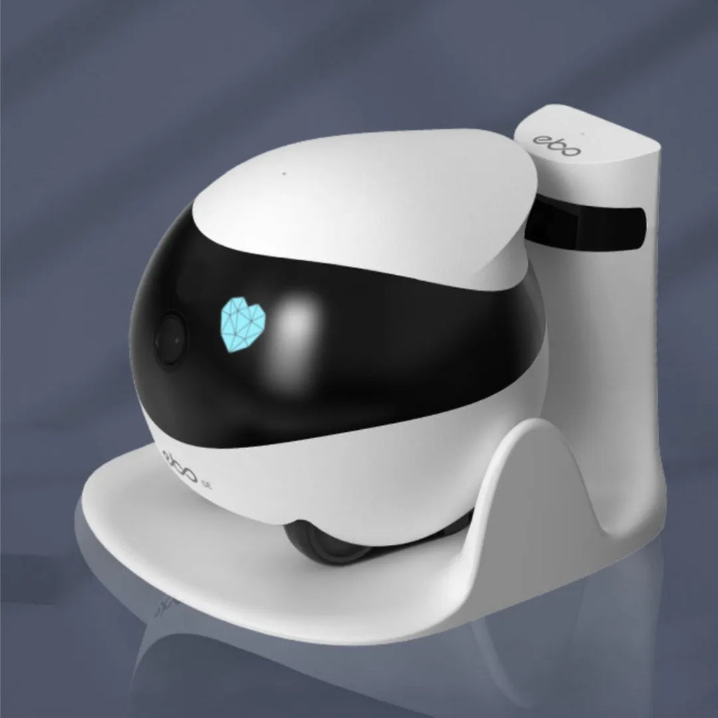 White mobile robot surveillance camera on a charging dock.