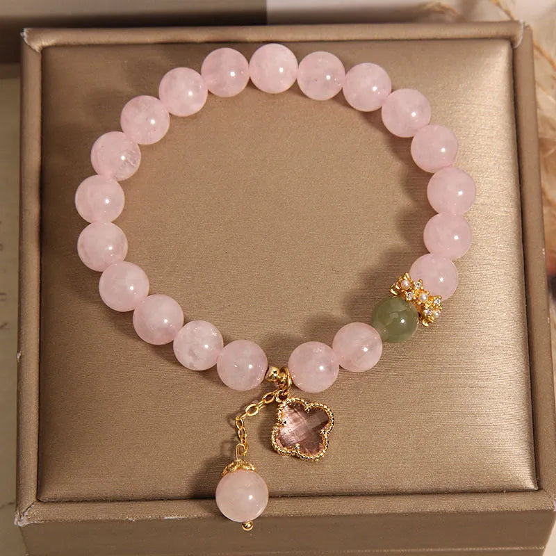 Pink crystal four-leaf clover pendant bracelet with alloy setting and rhinestone details