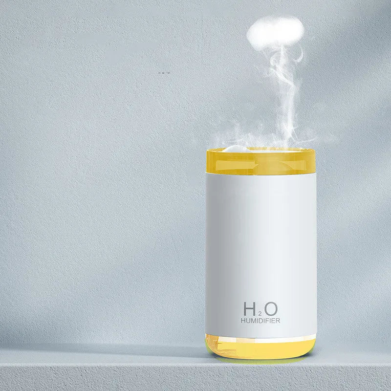 USB jellyfish humidifier producing smoke-ring mist with warm night light in blue, pink, or white colours