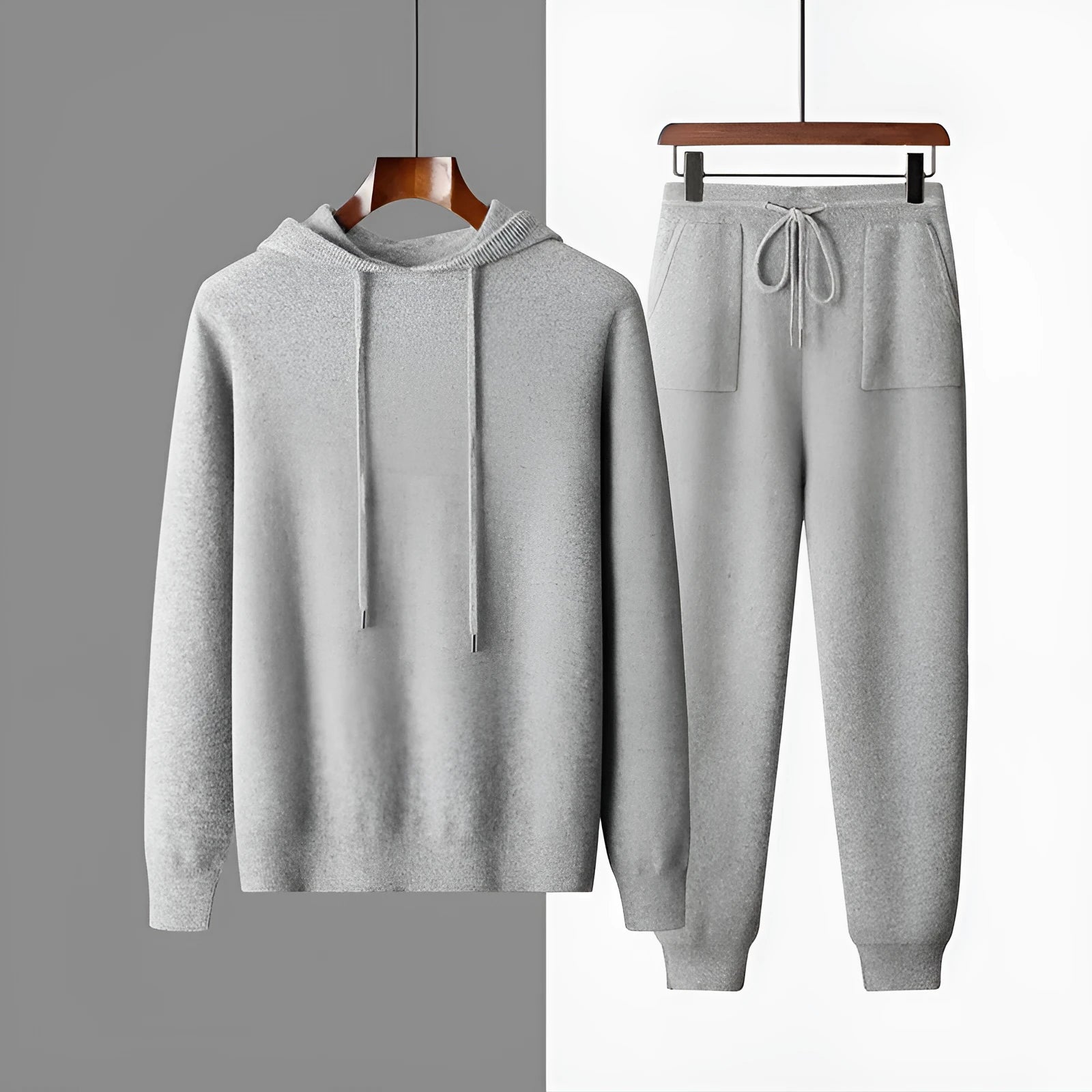 Man wearing a light grey hooded cashmere sweatshirt and matching casual trousers.