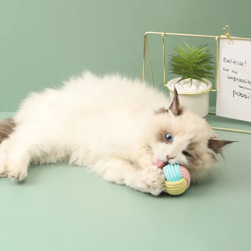 Handmade small blue powder, green blue, and pink green plush cotton ball cat toy for teeth grinding.