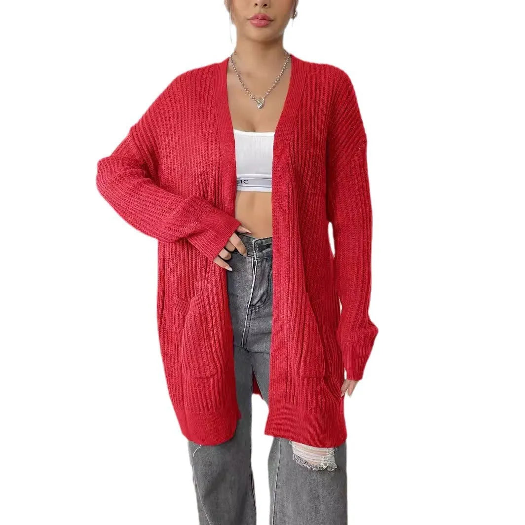 Women's dark green double pocket cardigan sweater with a V-neck and long sleeves laid flat.