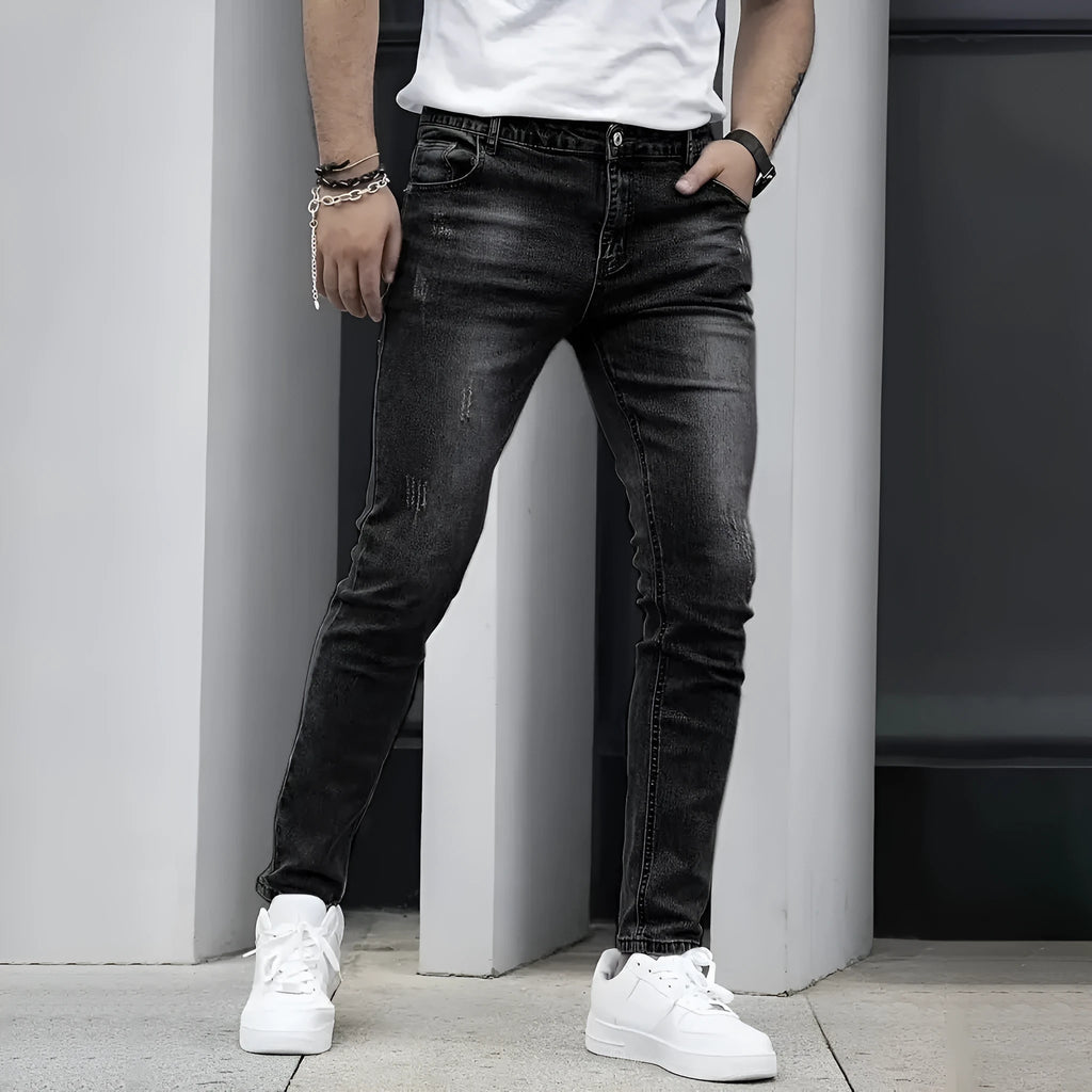 Men's straight-leg stretch jeans in black, dark blue, or grey, showing skinny leg opening and mid-waist fit.