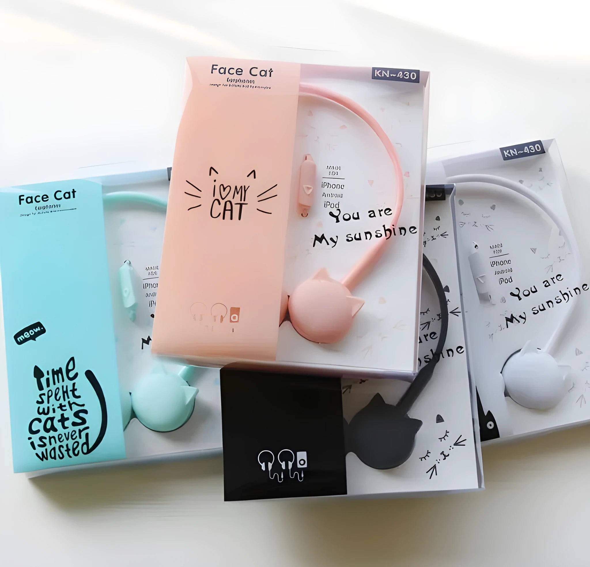 Cute cat stereo earphones with cat ear design in a choice of colours on a plain background