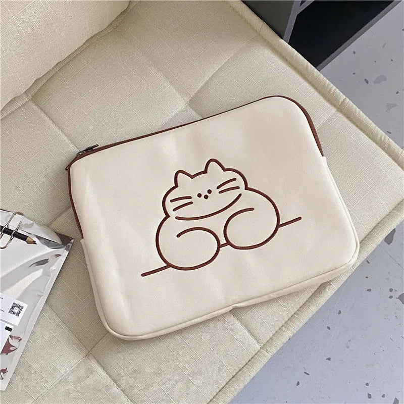 Embroidered cat design nylon tablet protective sleeve with zipper closure.