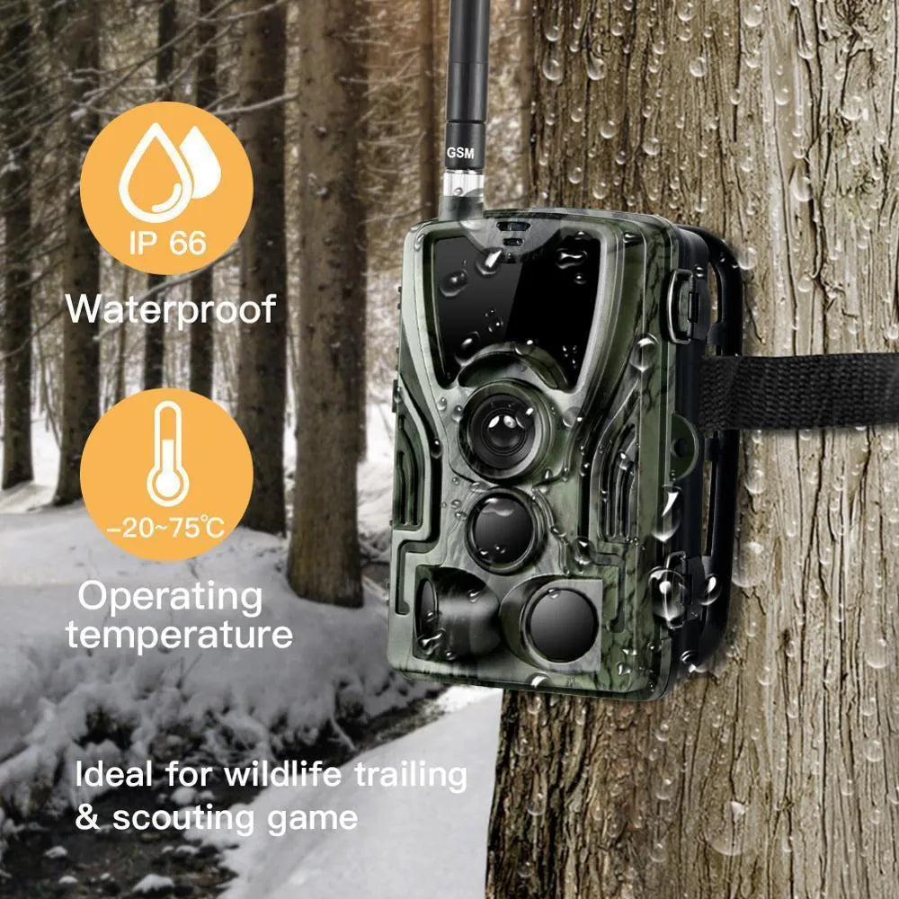 Green cellular trail hunting camera showing front lens and display on a tree mount.
