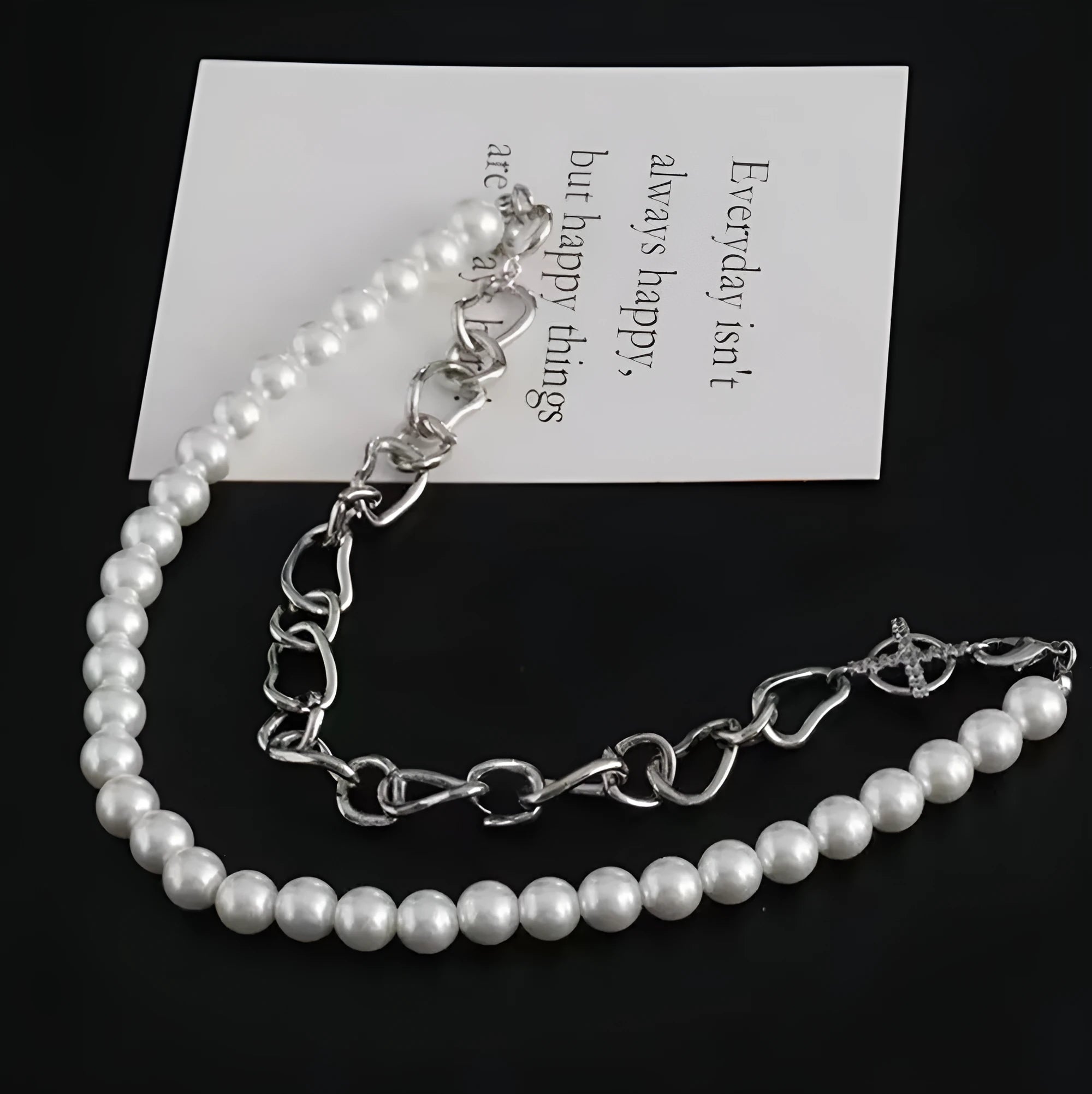 White asymmetric geometric acrylic pendant on a twisted chain necklace.