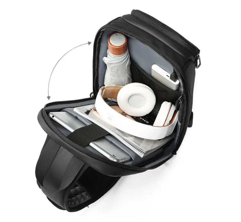 Black medium-sized PVC outdoor shoulder bag with an air cushion strap and internal organiser pockets.