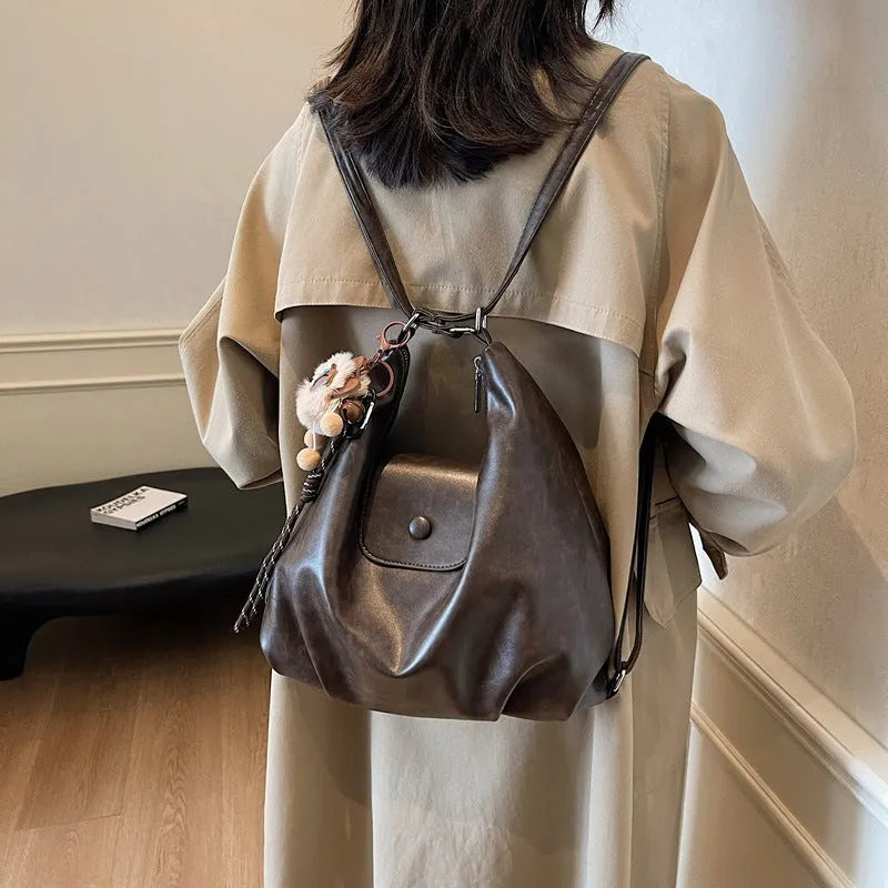 PU leather commuter backpack in horizontal square shape with single shoulder strap