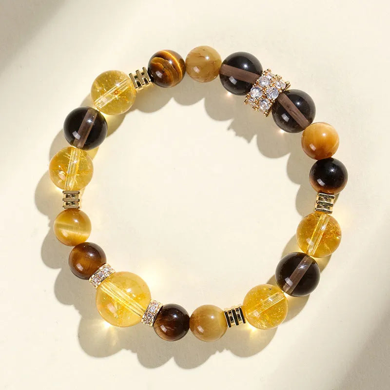 Close-up of a women's natural yellow bracelet with 10mm round artificial crystal beads on a string.
