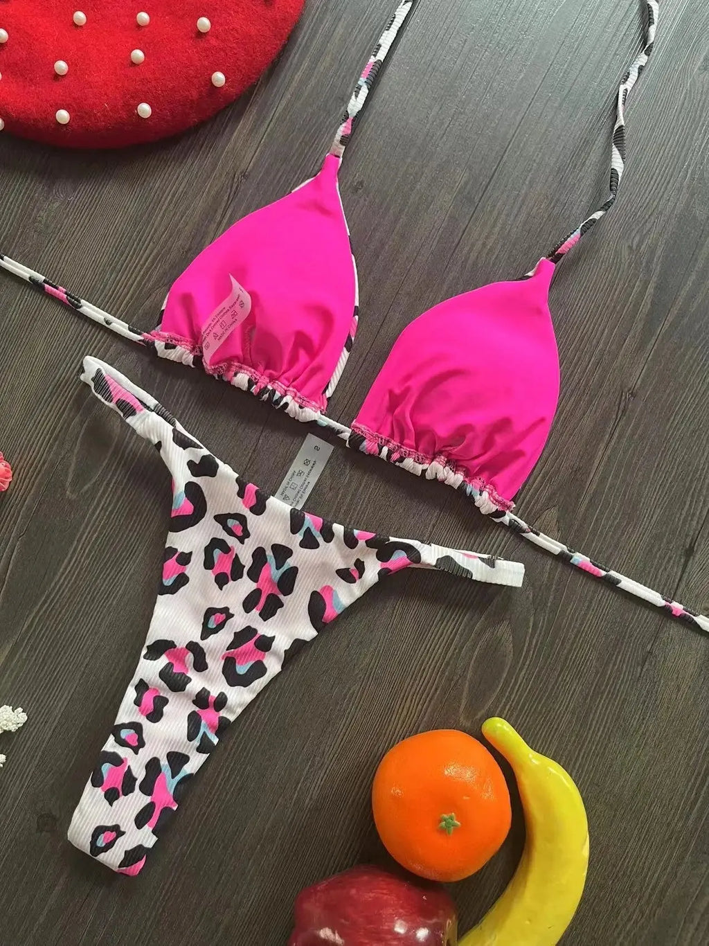 Women's printed bikini swimsuit on a hanger, showing briefs style and cotton lining detail.