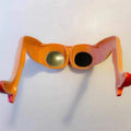 Orange novelty personality sunglasses with leg and hip design, measuring 15cm wide.