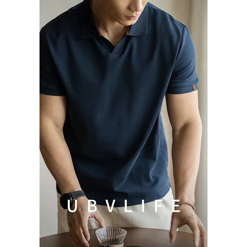 American-style short-sleeved polo shirt in blue on hanger showing regular fit and cotton blend fabric.