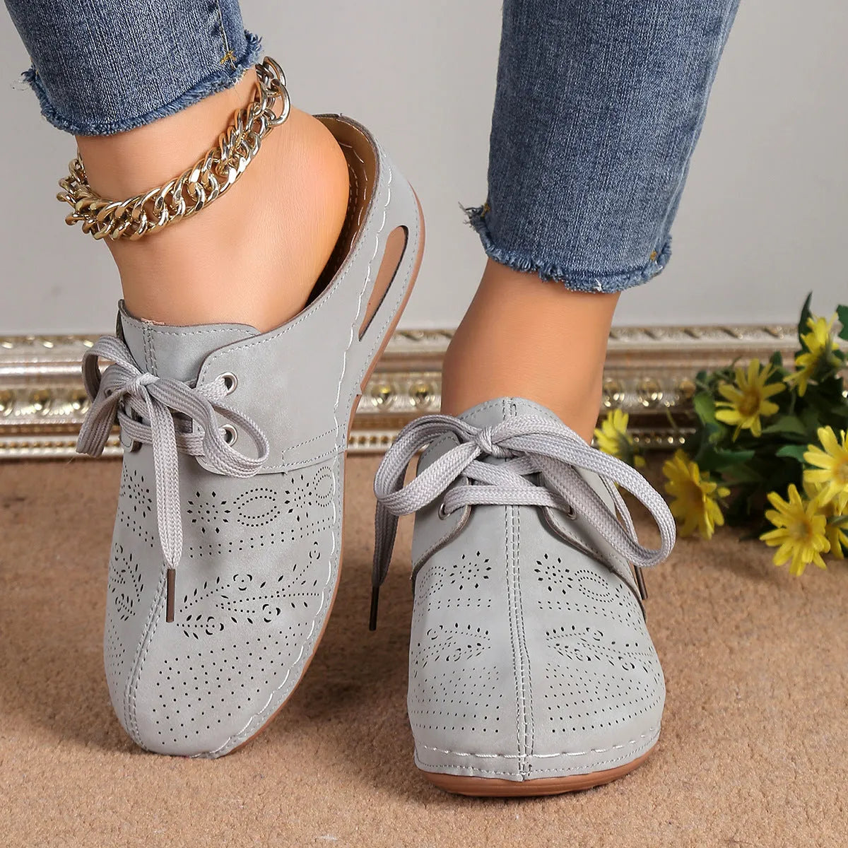 Women's suede lace-up wedge sandals in light grey showing hollow-out design and rubber sole