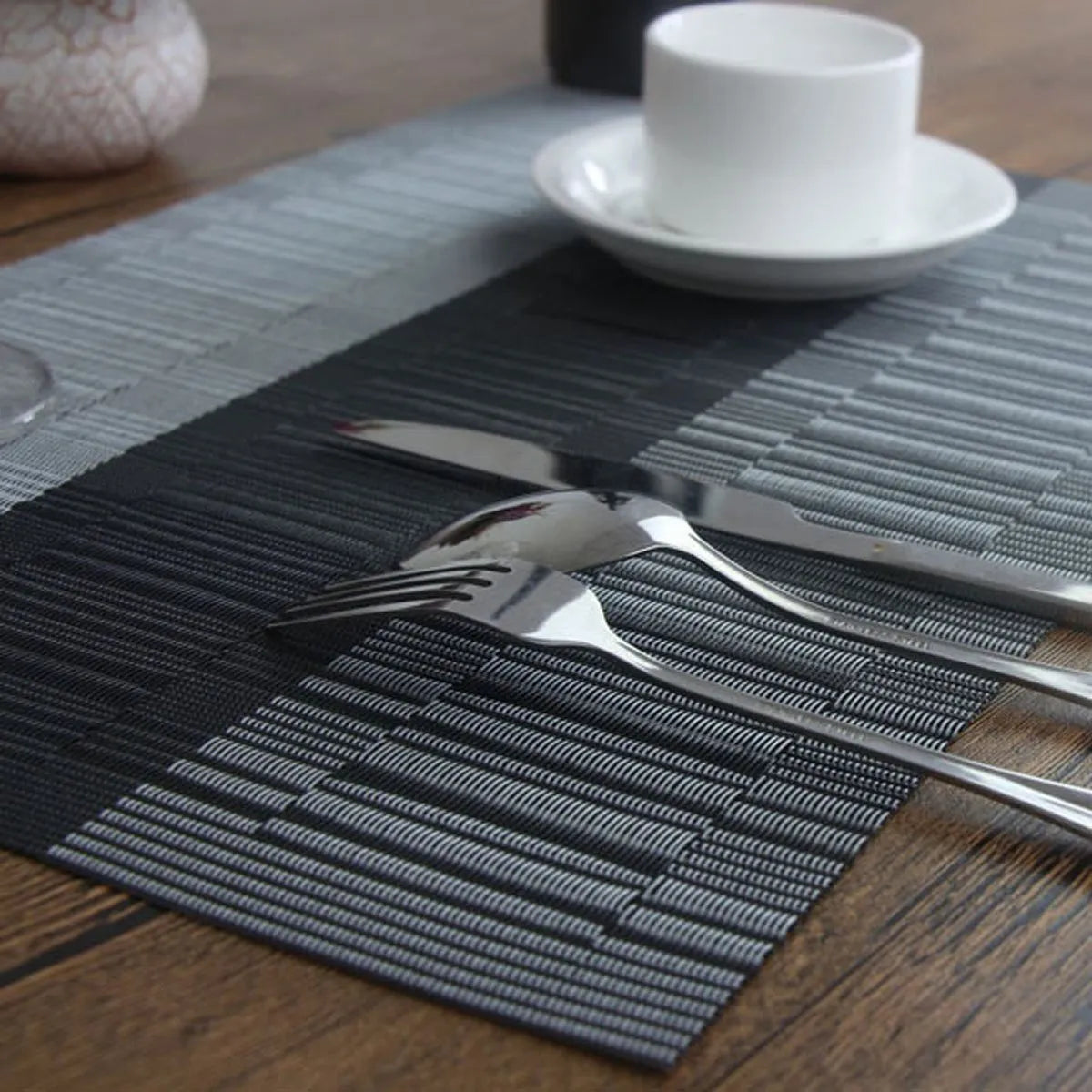 Modern PVC non-slip placemat in gradient bamboo black on a kitchen table.