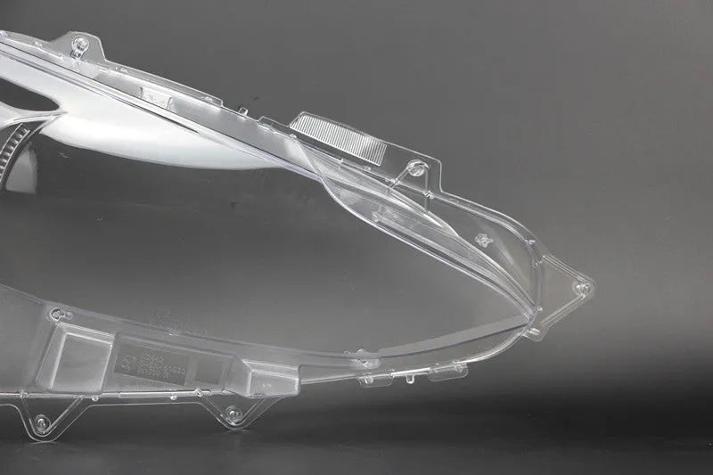 Mazda 3 Exela large headlamp cover replacement part with tube of snake glue adhesive.