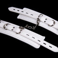 White PU sponge bondage set showing soft handcuffs, foot cuffs, and a neck cuff.