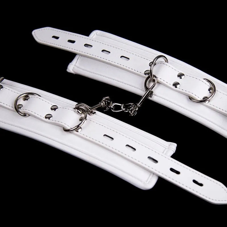 White PU sponge bondage set showing soft handcuffs, foot cuffs, and a neck cuff.