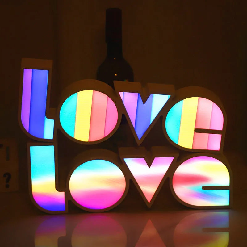 LED Love light with rainbow 'LOVE' lampshade on a table.