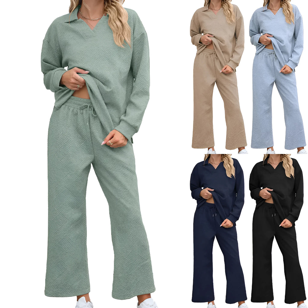 Women's black knitted jacquard suit set with long sleeve top and elastic waist cropped trousers laid flat.