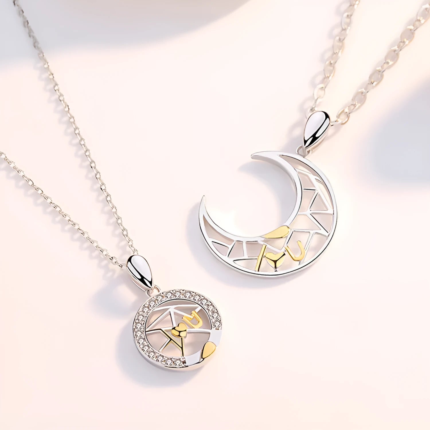 Copper sun and moon couple necklace with electroplated finish on a cross chain.
