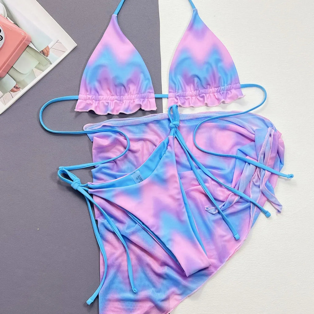 Women's tie-dye patterned bikini swimsuit set with bra, panties, and skirt.