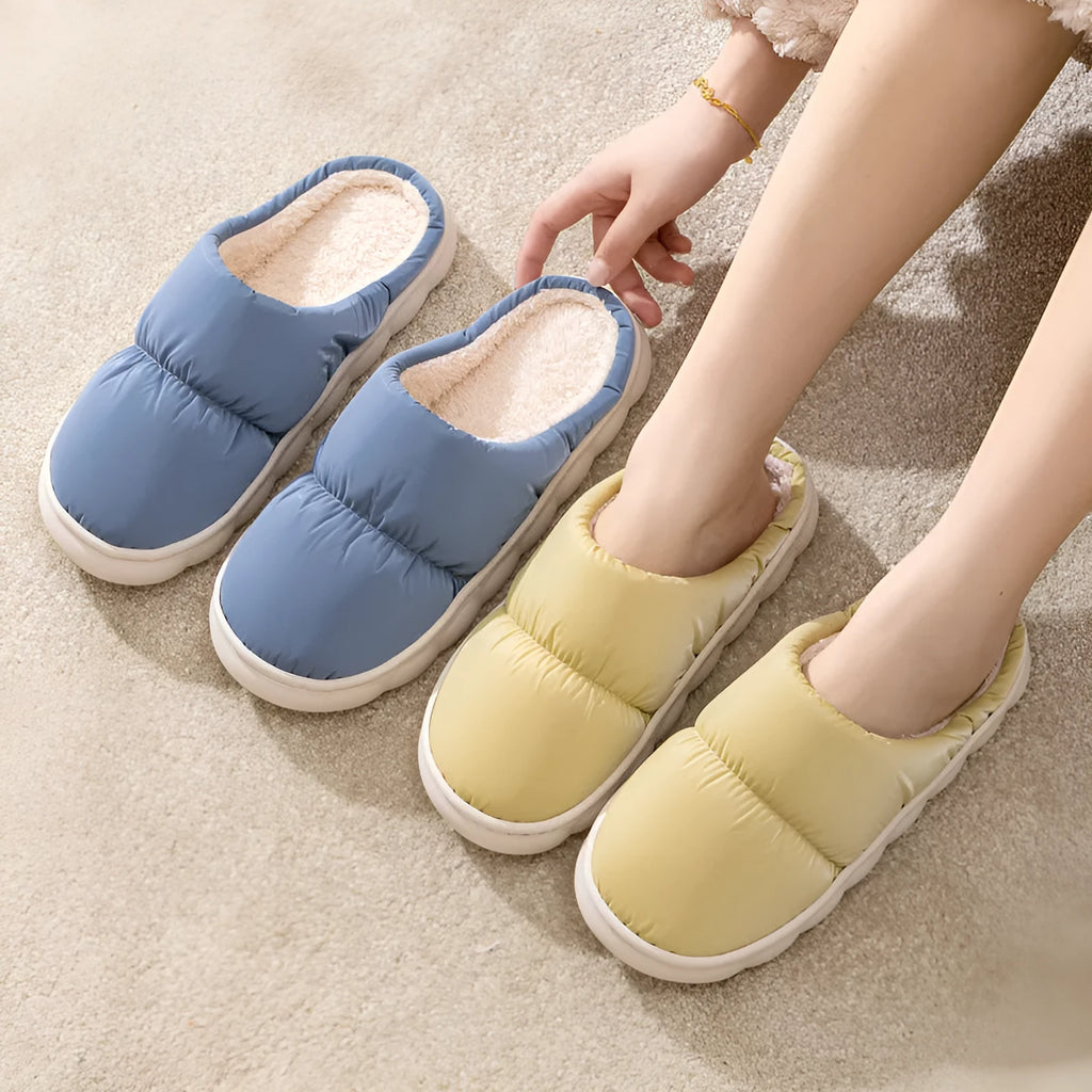 Blue down cotton slippers with thick rubber sole and plush lining, shown from side.