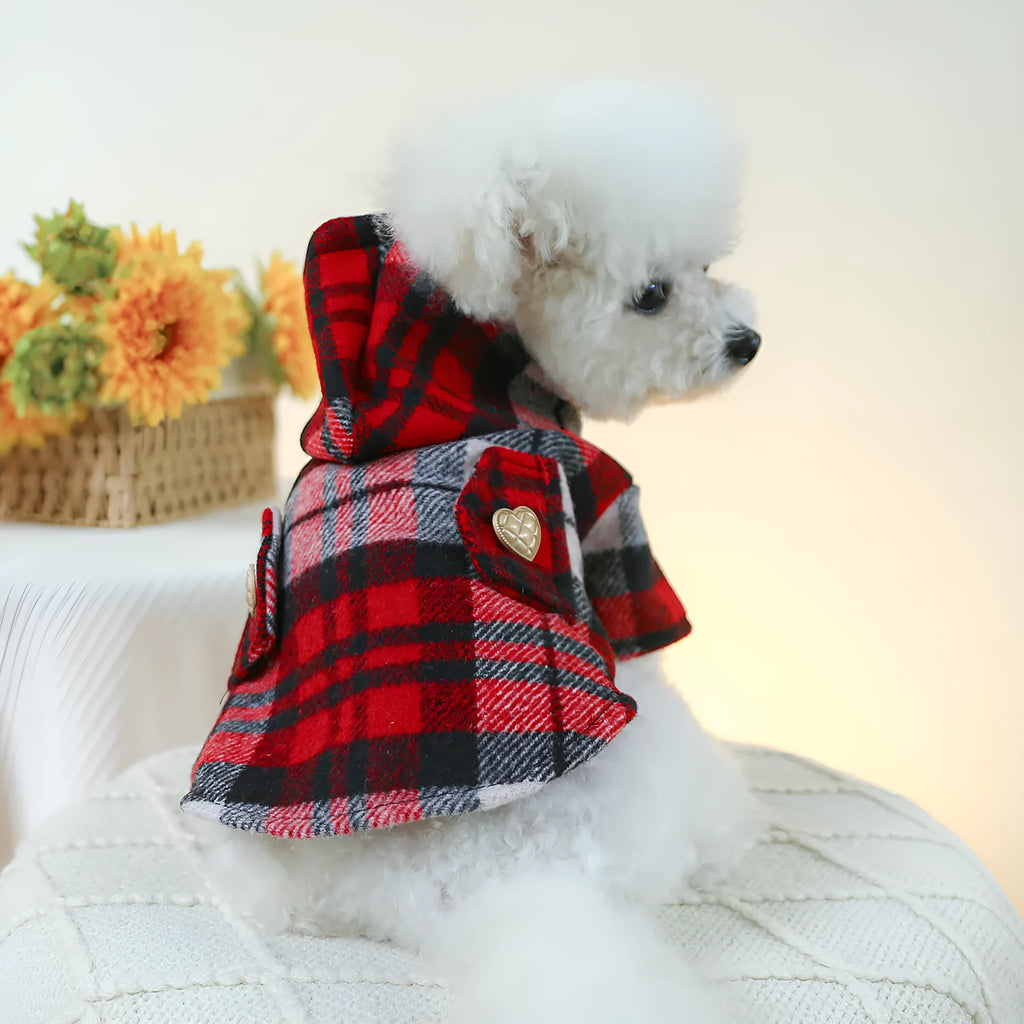 Red plaid trench coat for a dog, shown alongside a black houndstooth version, on a mannequin.