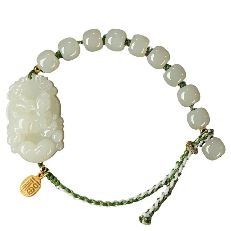 Hetian jade rabbit charm bracelet with sterling silver card on a white ice cotton rope.
