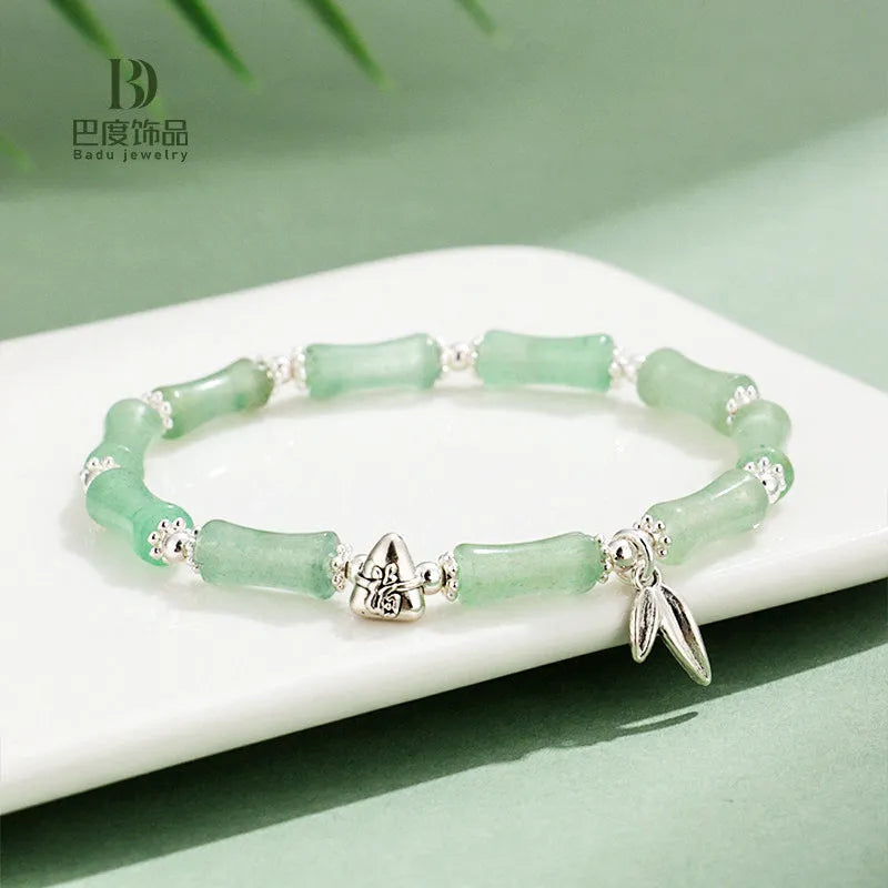 Green aventurine bamboo strawberry quartz crystal bracelet with mixed natural stones on wrist