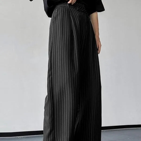 Men's black vertical striped pleated casual trousers showing elasticated waist and leg detail