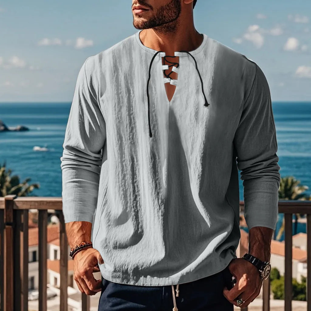 A loose-fitting solid colour cotton blend beach ruff shirt on a hanger.