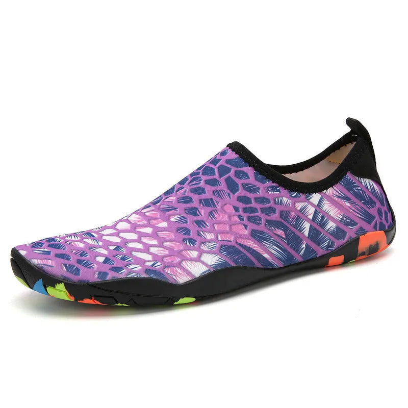 Blue Lycra beach wading shoes for men and women on a sandy shore.