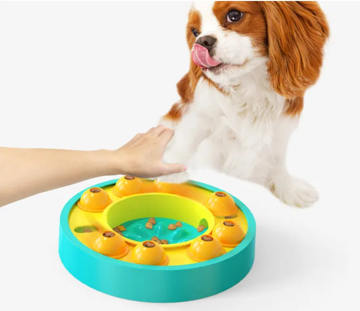 Round blue interactive dog slow feeder puzzle toy with central column and food turntable on a table