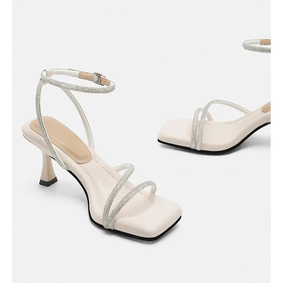 Women's silver square toe rhinestone ankle strap high heel sandals on a white background.