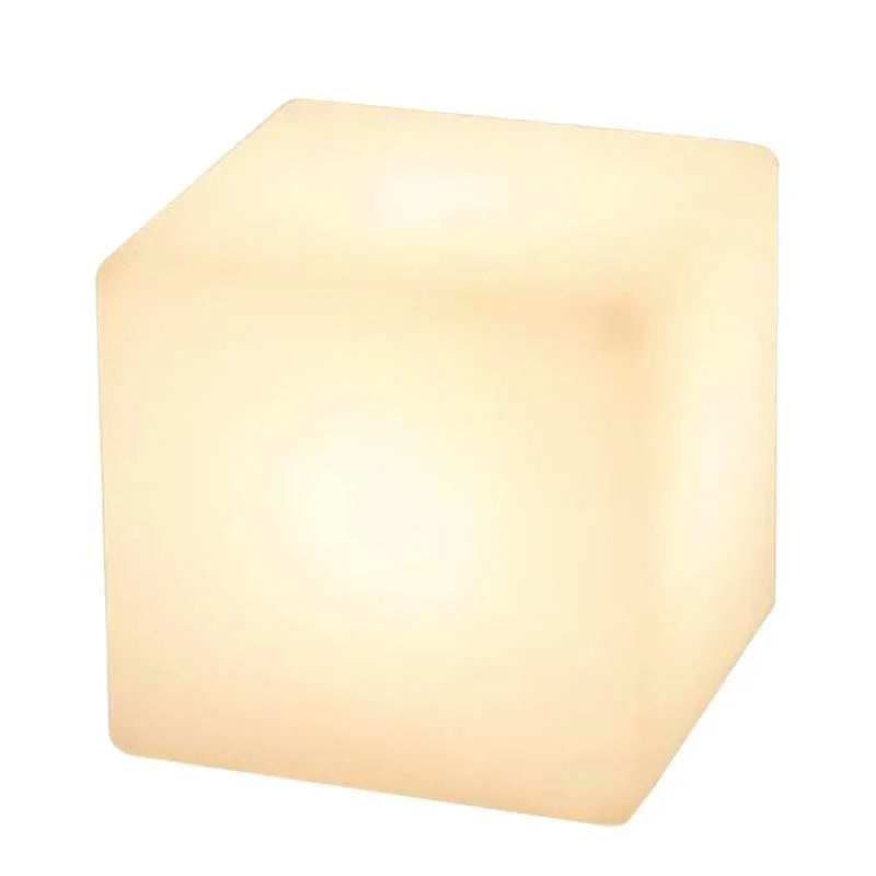 Modern square LED cube light stool in outdoor garden setting showing waterproof IP65 construction
