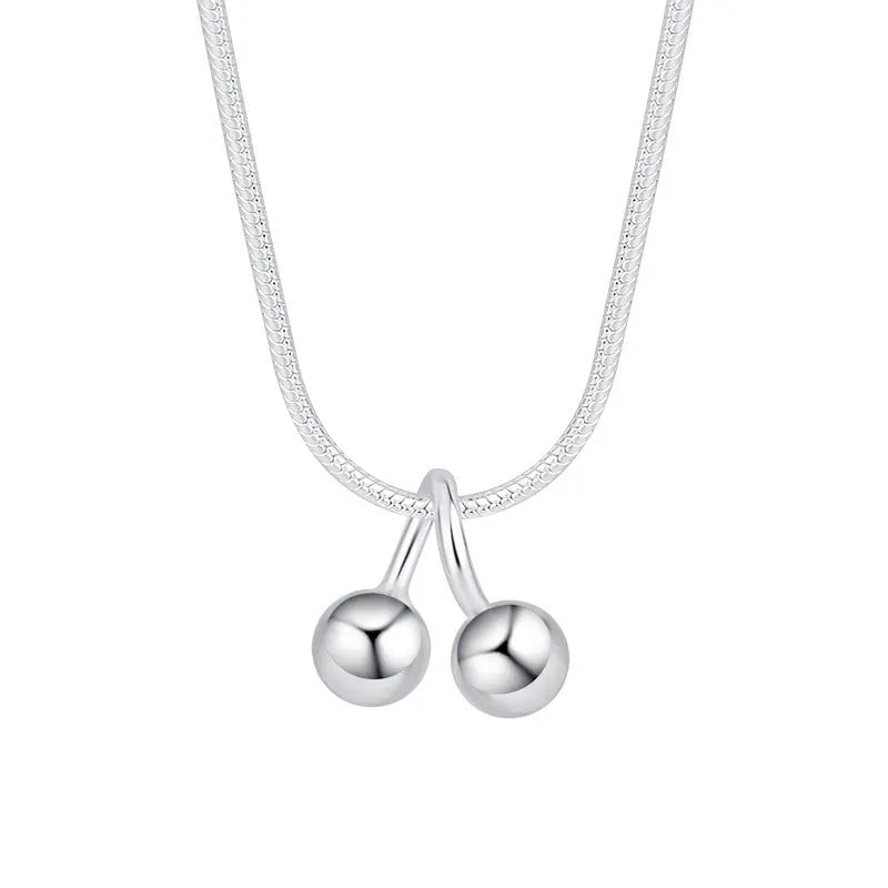 Silver cherry necklace for women with adjustable snake bone chain on a white background.