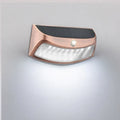 Solar-powered outdoor wall lamp with smiling face design in ABS plastic.