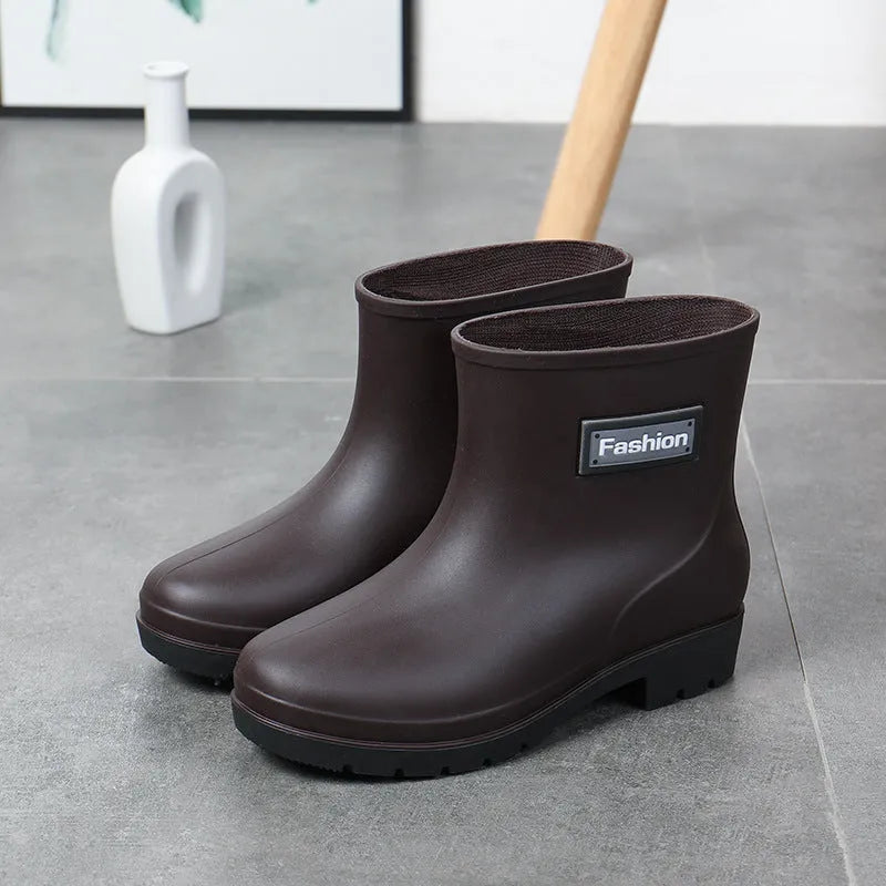 Women's black mid-calf rain boot made of PVC with a low heel.