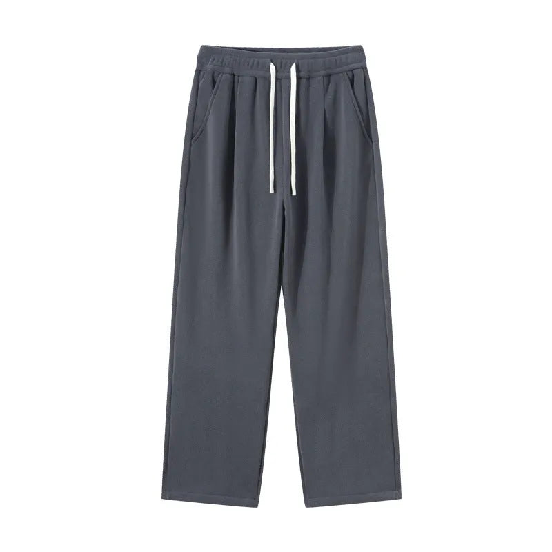 Man wearing apricot coloured loose-fit polar fleece winter sports pants with a drawstring waist.