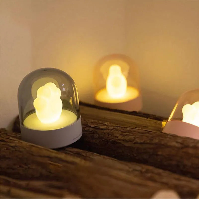 Grey and pink cat paw shaped night light with USB charging port and music box functions