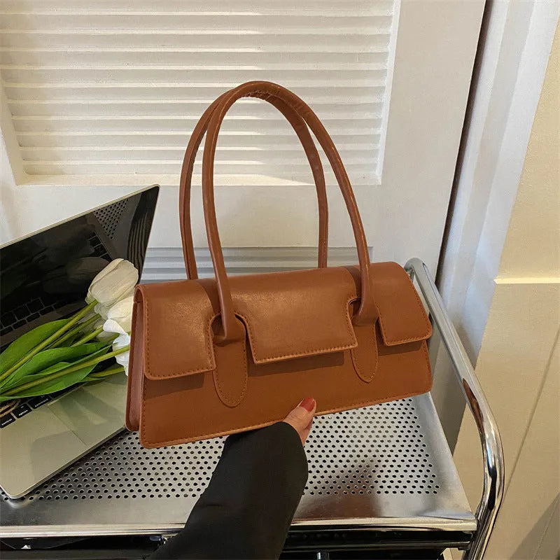 Women's horizontal square PU leather shoulder bag in black with stitching detail and sandwich pocket design